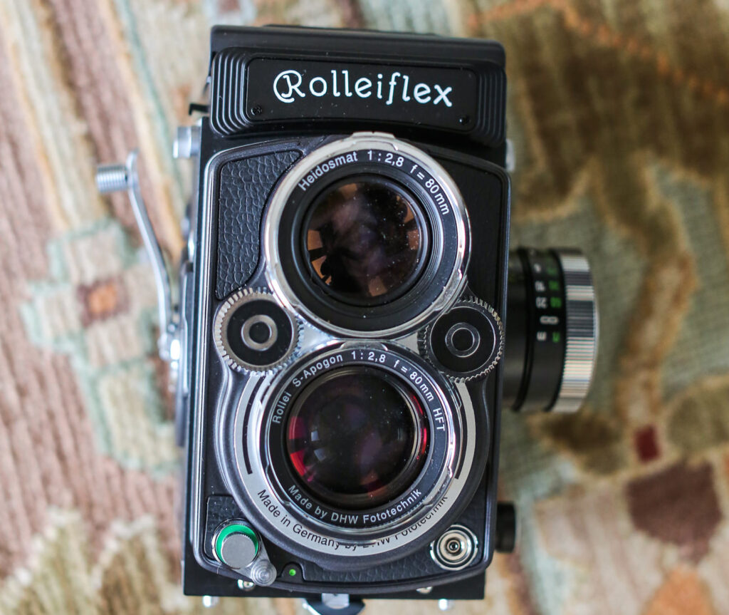 analog camera Rolleiflex 2.8F, lying on a wooden table