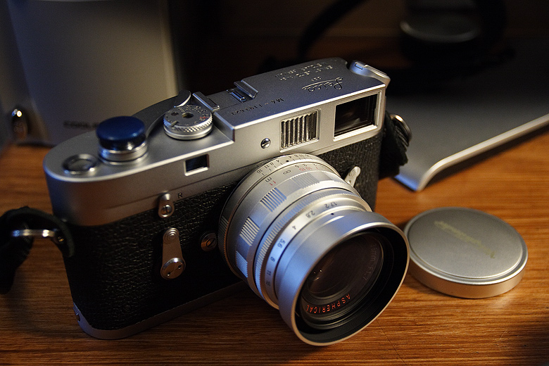 Leica M4 in silver with curved lever on a wood desk