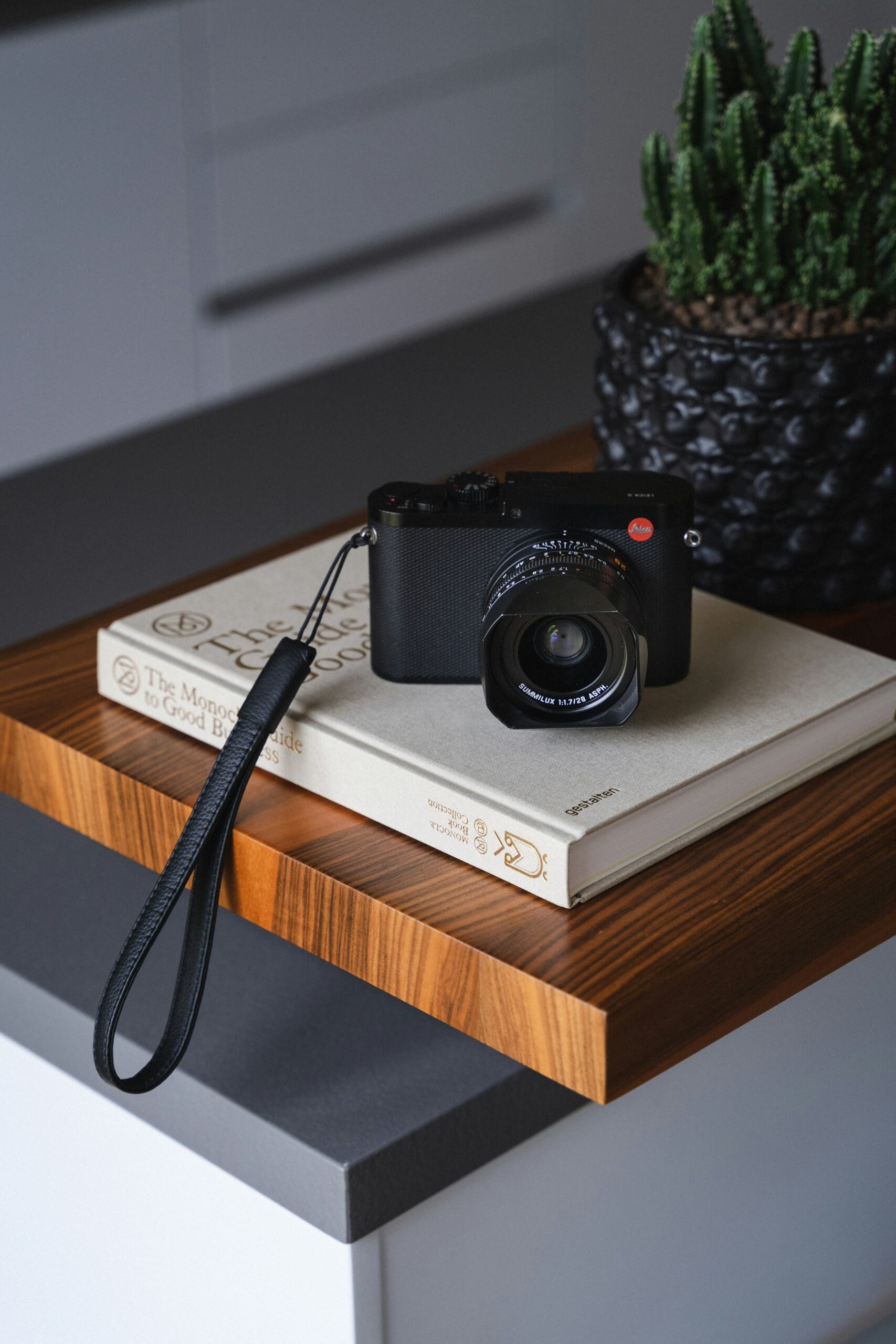 Analog camera Leica M6 laying on book
